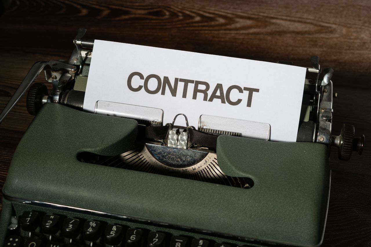 hero-img-02 Close-up of a vintage typewriter with a paper labeled Contract, evoking a retro office theme.